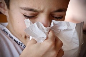 Person blowing nose during illness